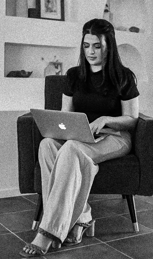 Meg, founder of Squareposh, working on a laptop